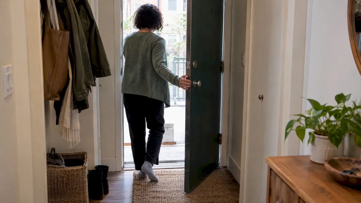Person closing the front door after ritual